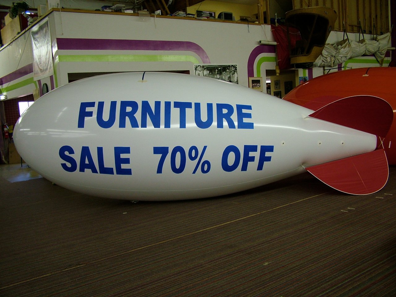 21-foot custom helium advertising blimp promoting a furniture business