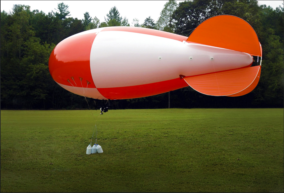 Orange and white checkered 21-foot helium advertising blimp with custom graphics