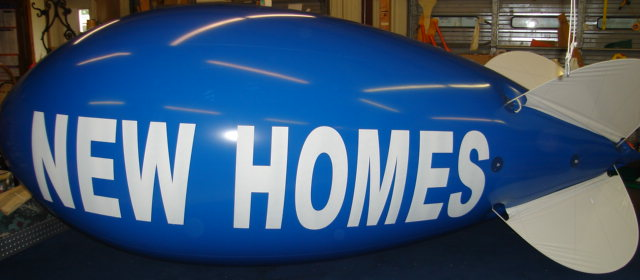 Custom New Homes helium advertising blimp for Texas homebuilder marketing and model-home events